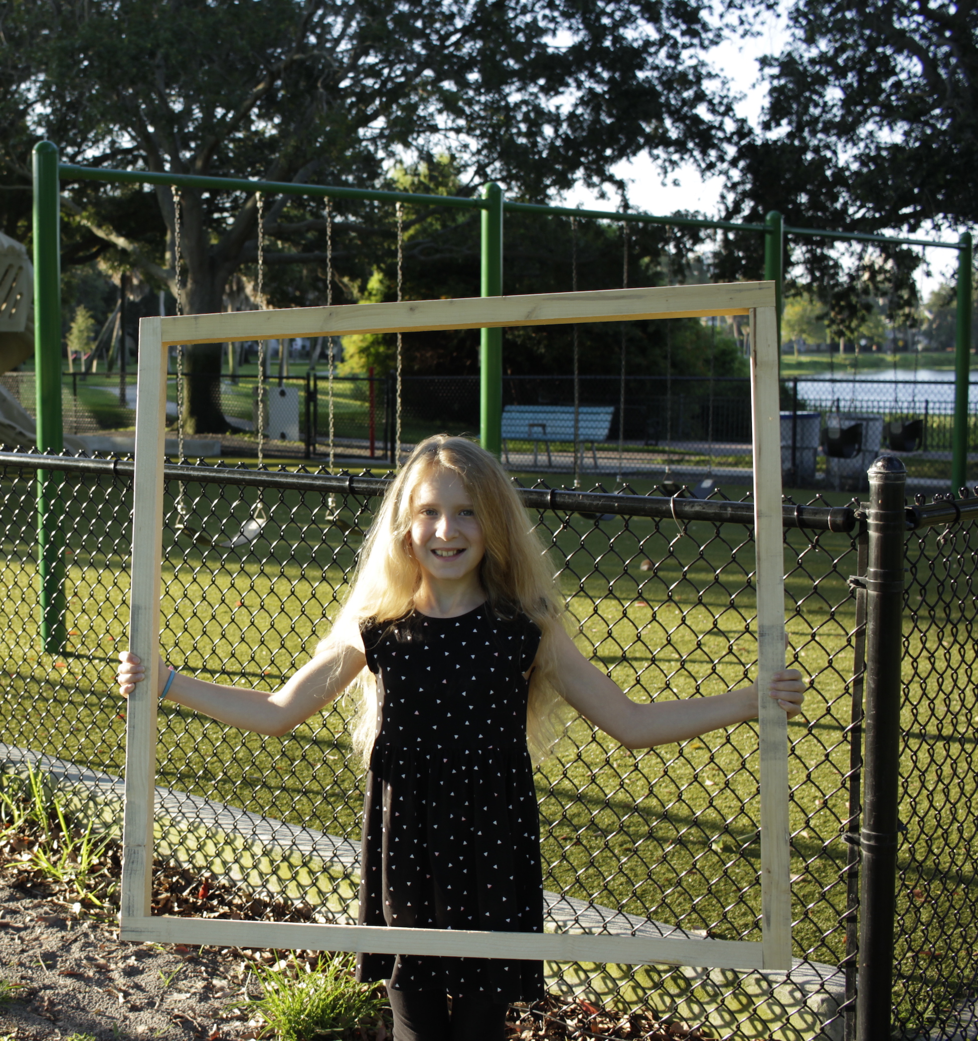 Photograph of girl with square meter. Length, almost full arm length. Width, about head to knees.