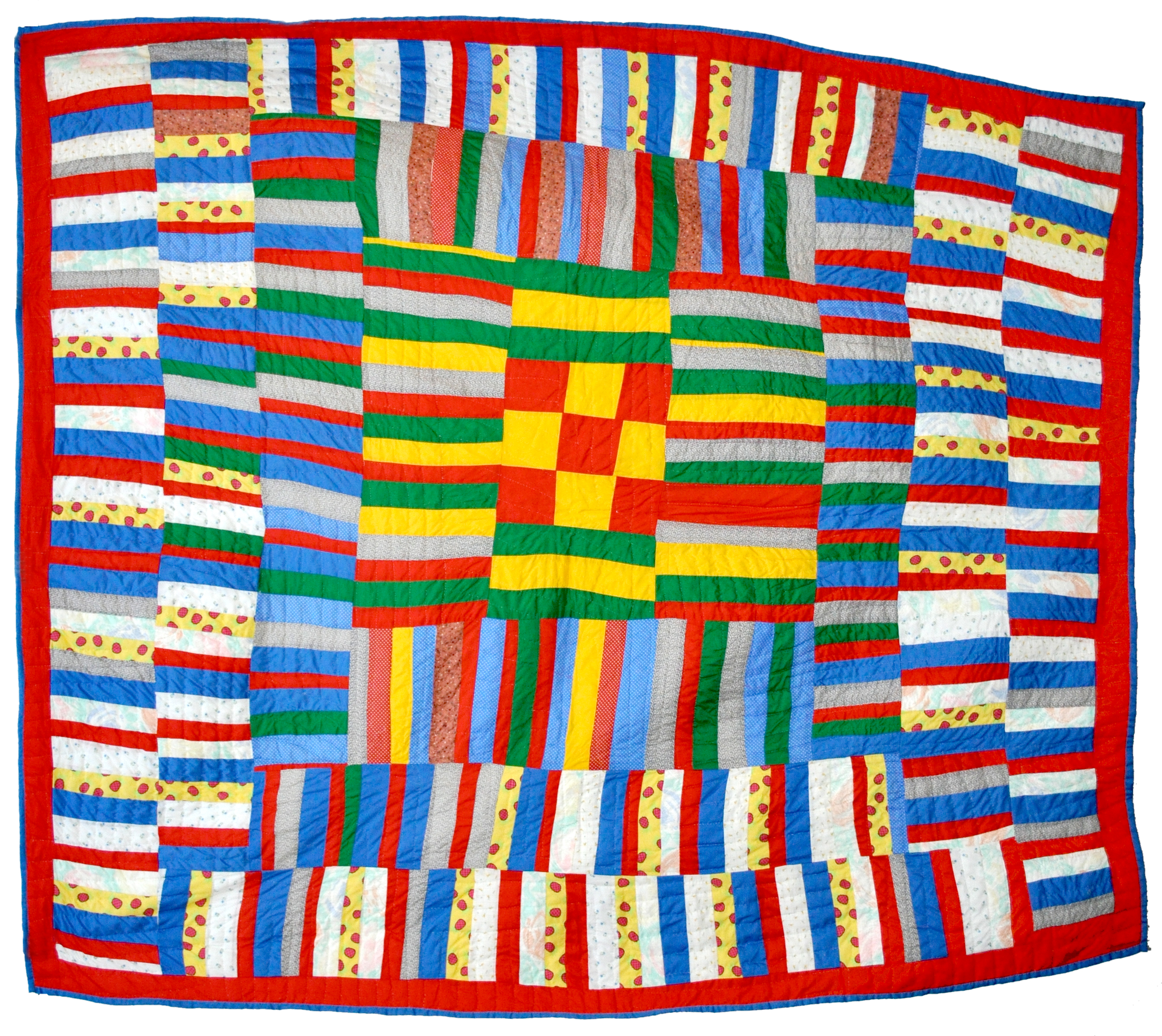 Photograph of blanket. Many colors, shapes. Rectangles, squares, circles.