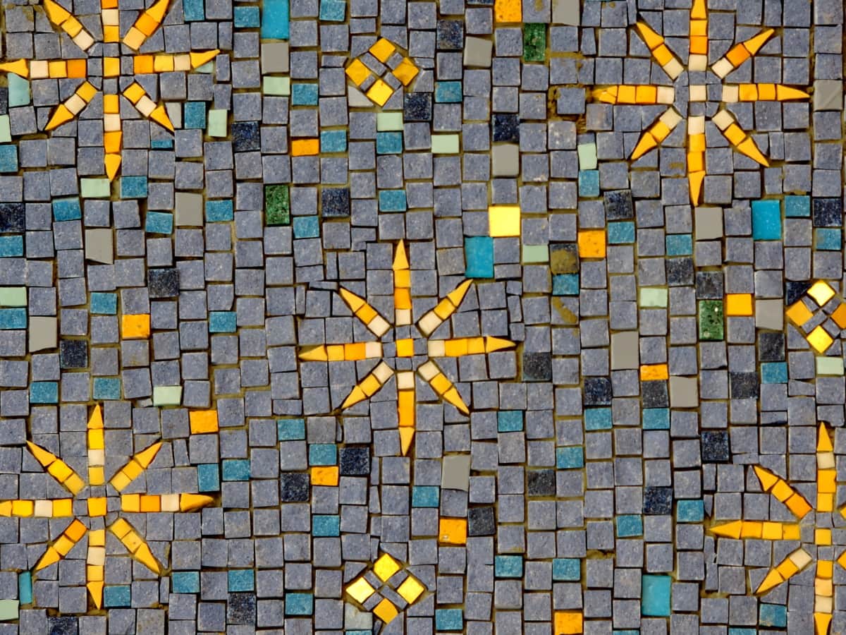 A pattern made of tiles, different shapes and colors.