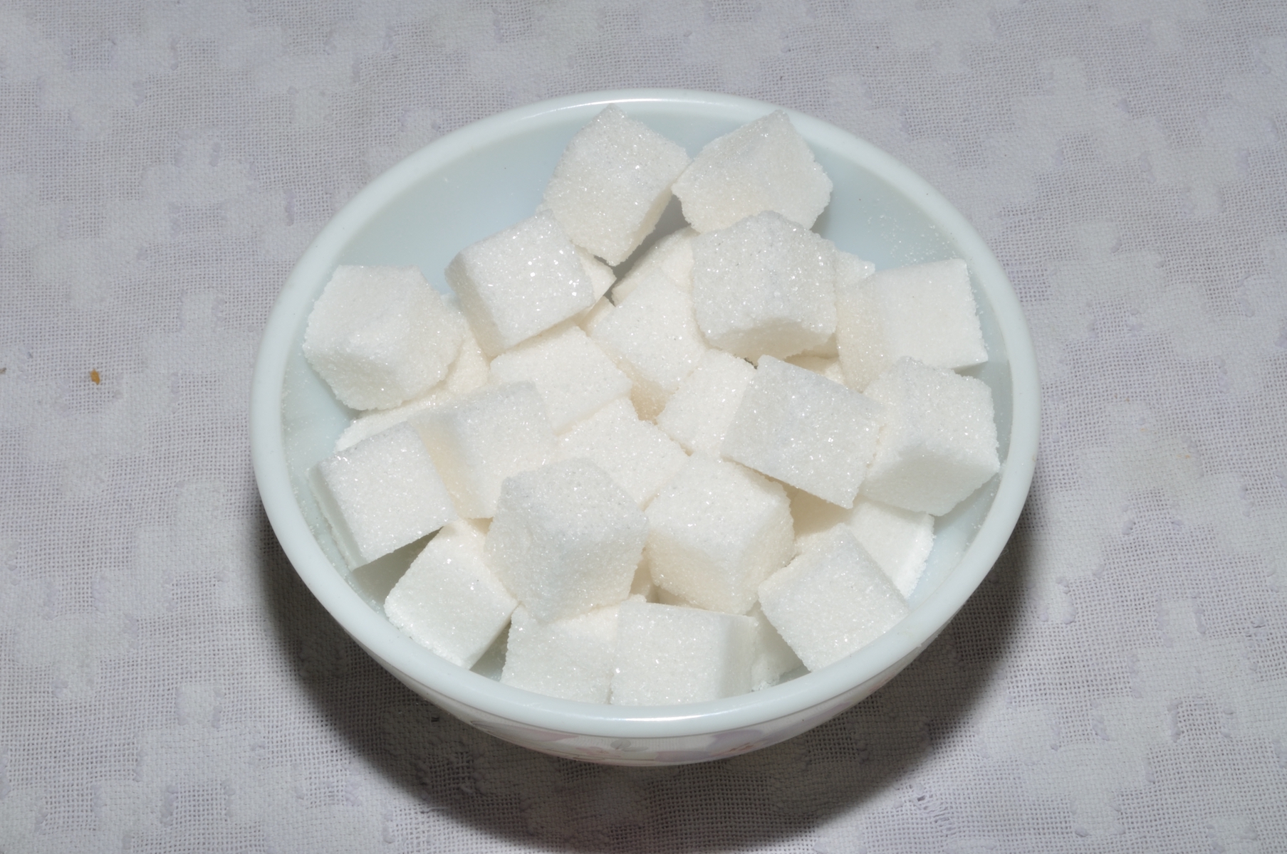 photograph of a bowl of sugar cubes