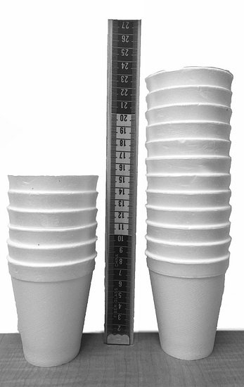 a image of 2 stacks of cups next to a ruler